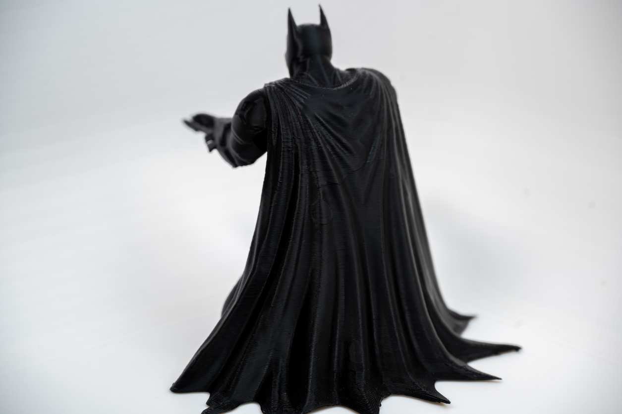 Rear view of bat inspired pen holder with textured cape folds