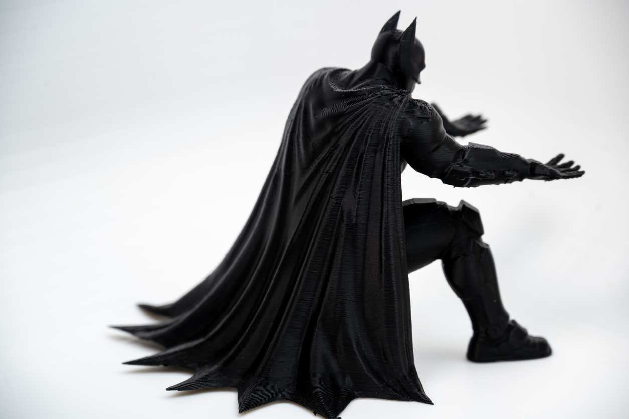 Bat inspired pen holder desk figure with pencil across hands close-up