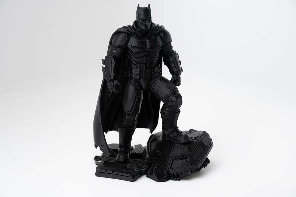 3D printed superhero diorama front view in black PLA with rubble base