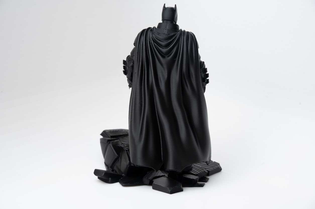 Rear view of 3D printed superhero diorama highlighting cape folds and base rubble