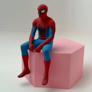 Sitting spider hero figure perched on a pink display block, front view