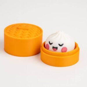dumpling fidget clicker toy in orange steamer-style box with lid