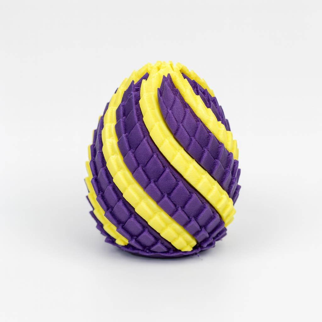 Dragon Egg Fidget Toy in purple and yellow spiral scale texture