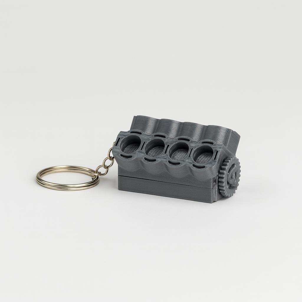 Side view of V8 engine block keychain with gear detail