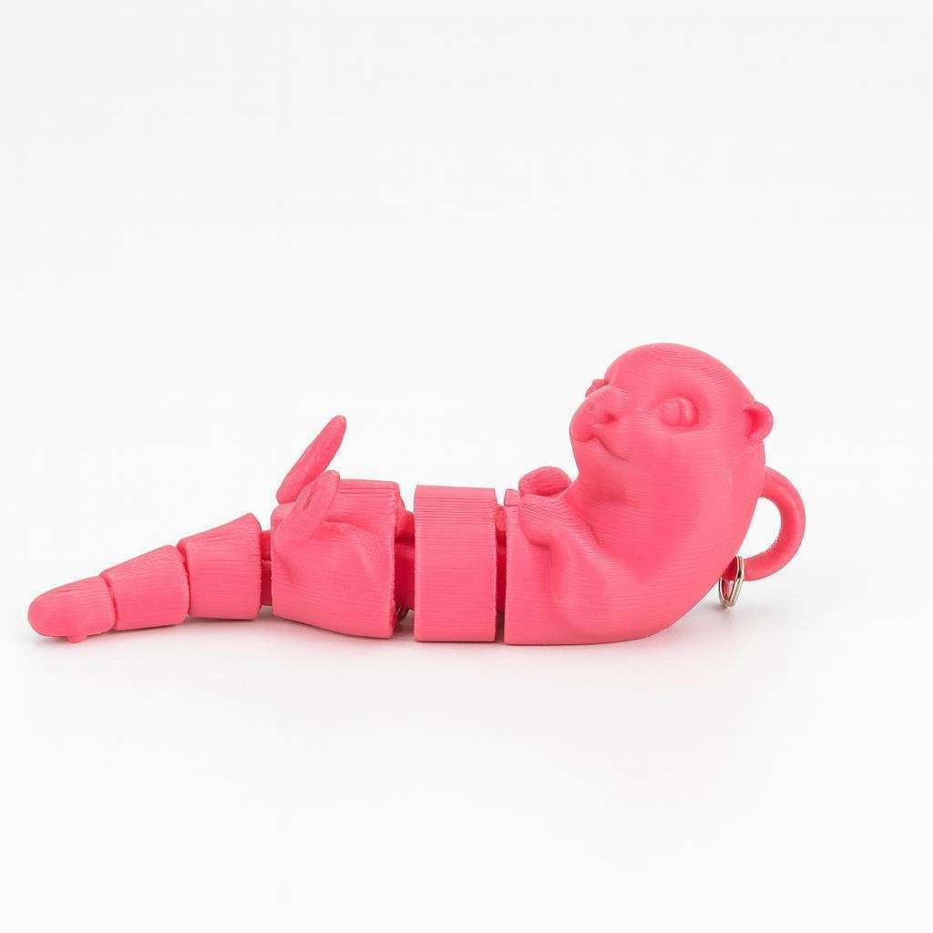 Pink flexi otter keychain showing segmented articulated body