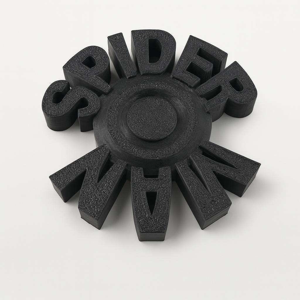 Top view of black PLA spinner with bold raised letters around center hub
