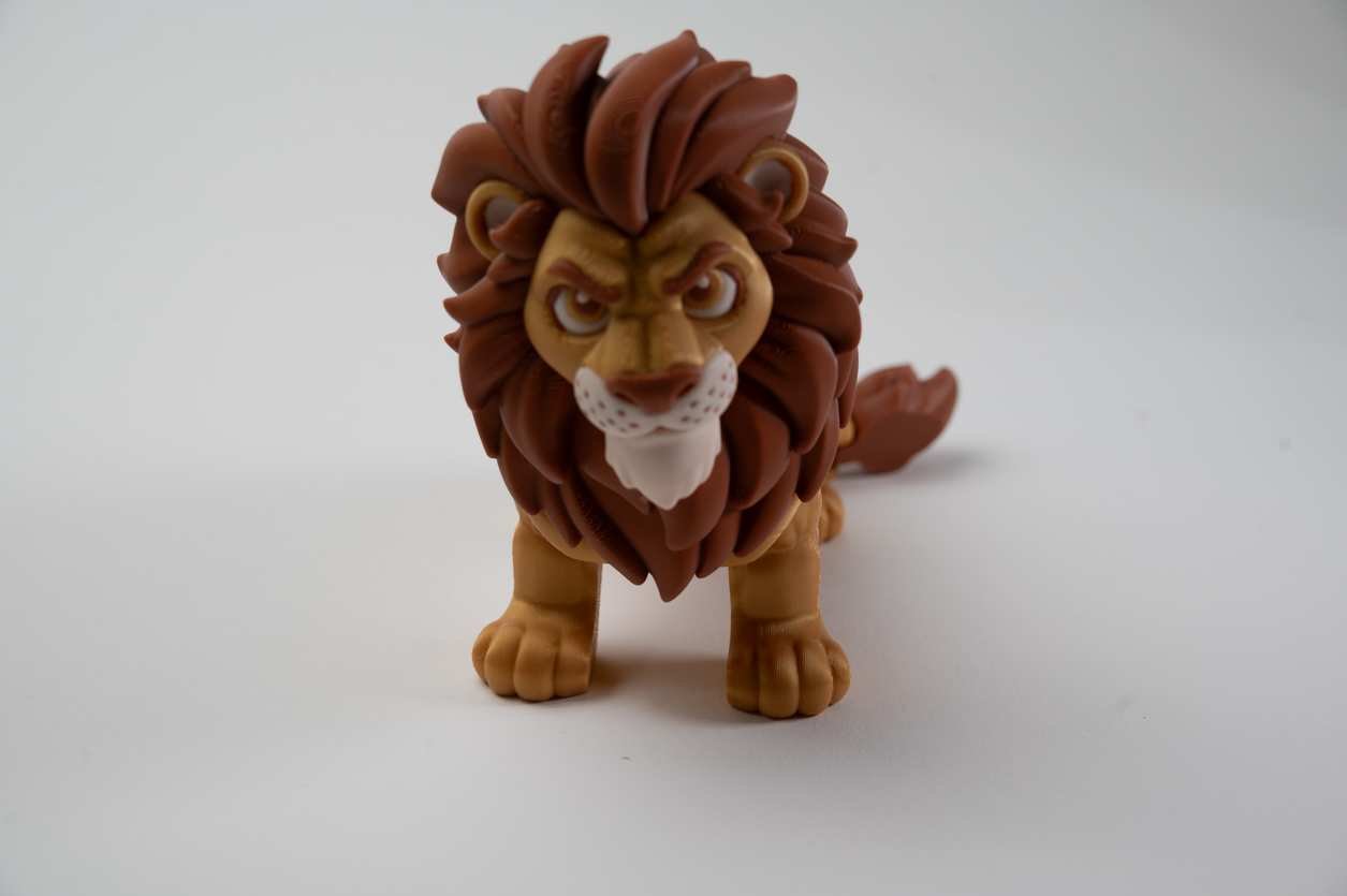 Front view of poseable lion figurine with expressive face and mane