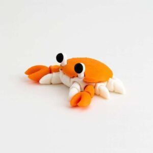 3D printed flexi crab in orange and white on a white background