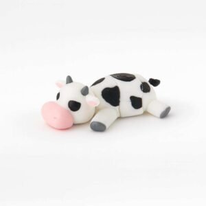 Flexible cow fidget toy 3D printed in PLA lying down